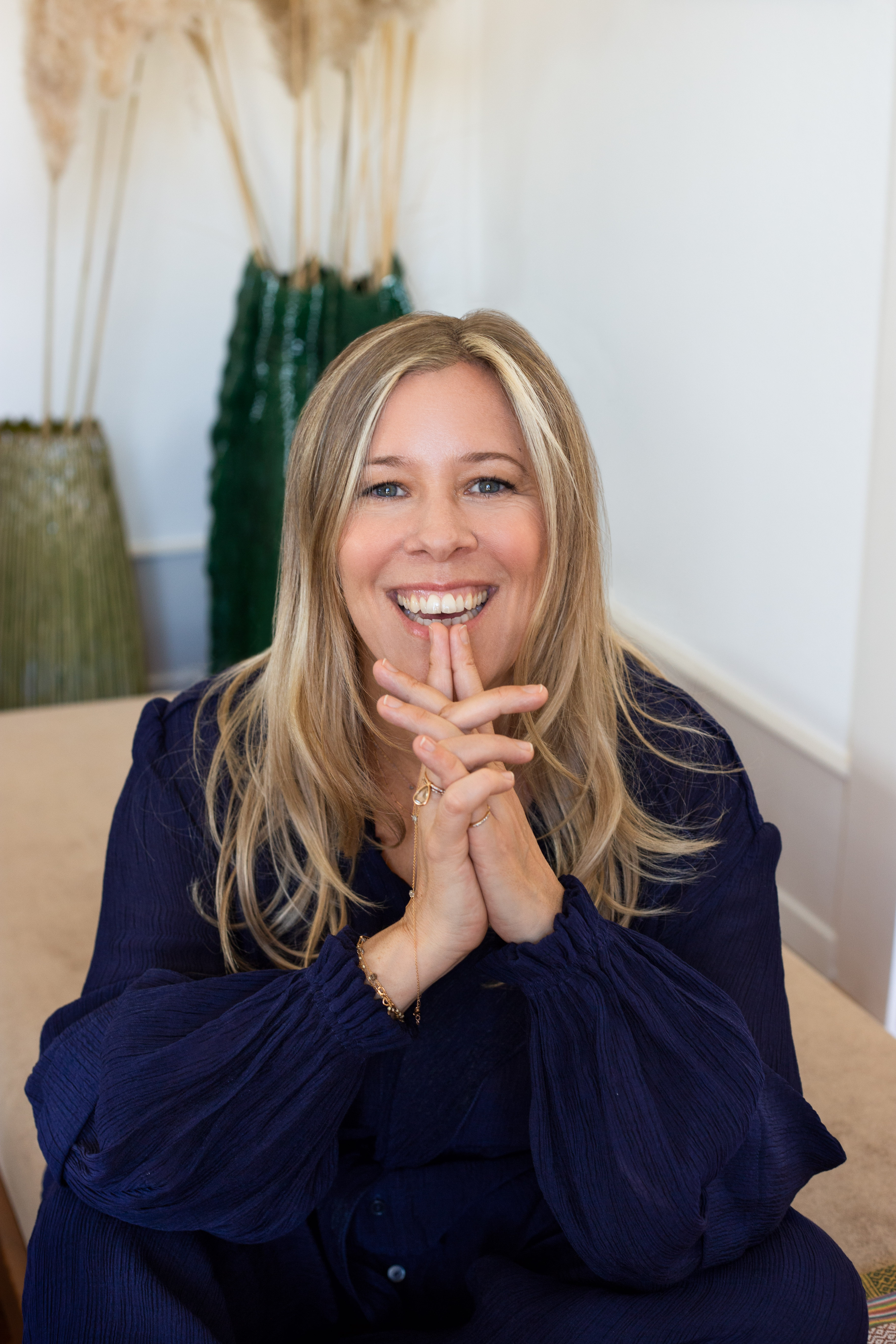 A portrait of meditation teacher, coach and writer Anne V Muhlethaler wearing a navy blouse