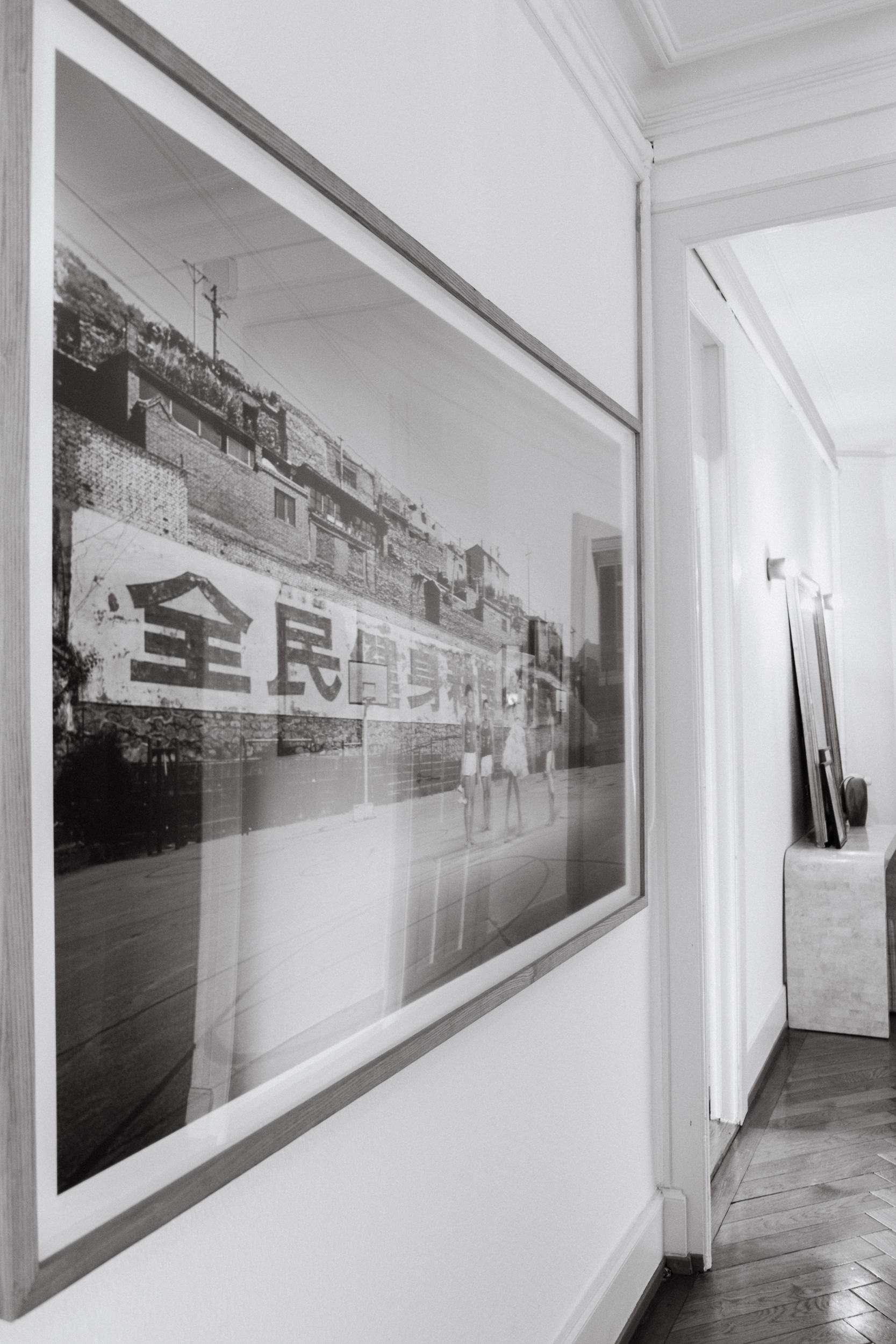 A photograph of the hallway featuring a large framed photograph by Quentin Shih