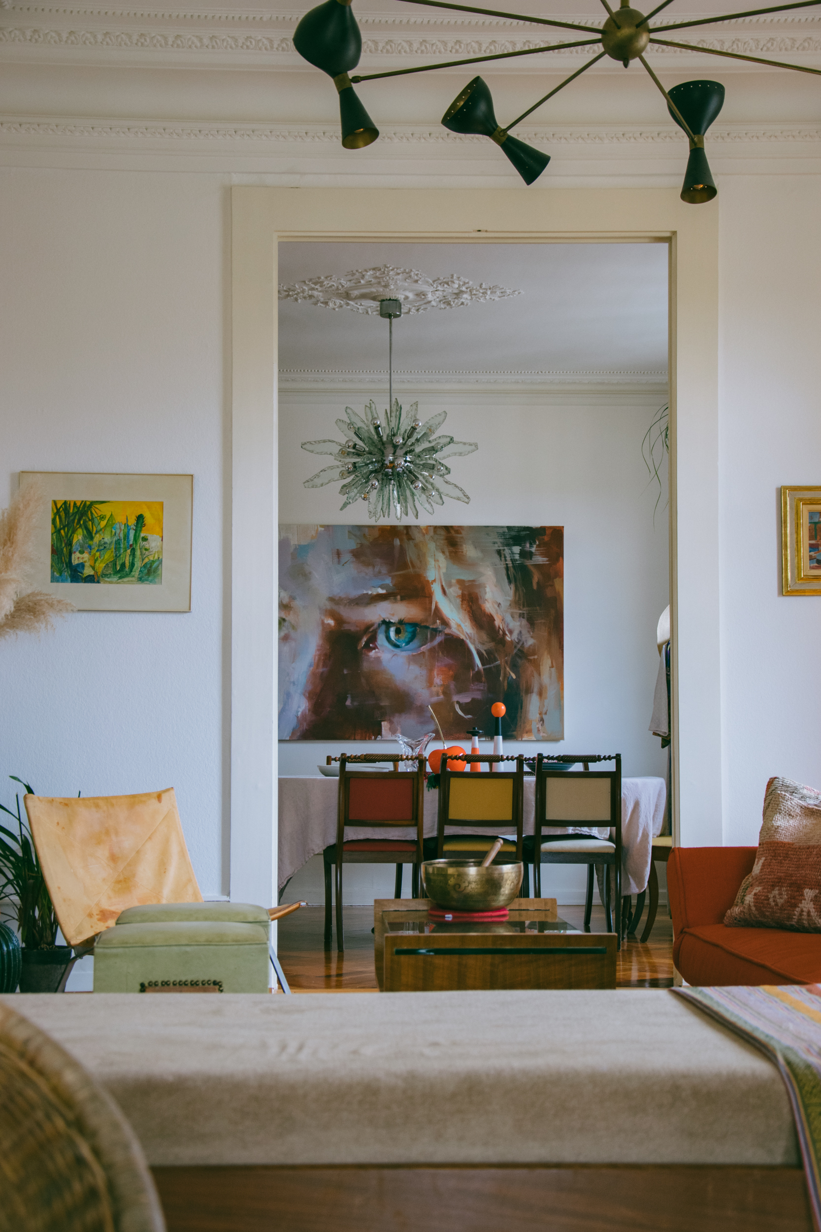 Another angle showing the salon and the dining room featuring two vintage chandeliers and a portrait of Anne by artist Jerome Lagarrigue