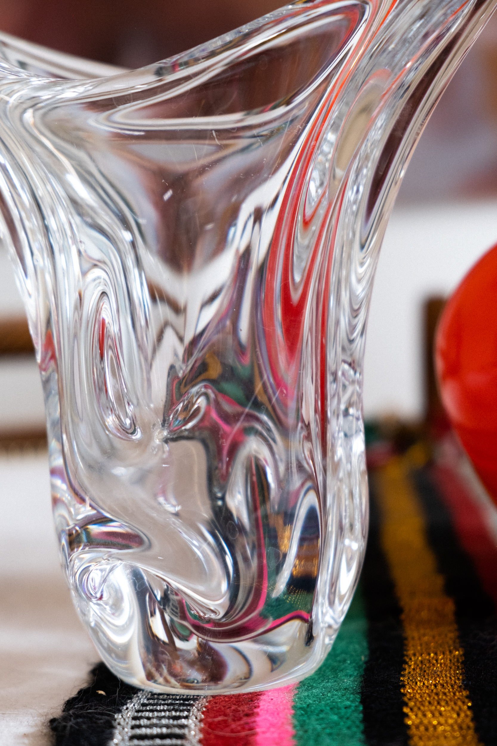 An up close shot of a vintage crystal vase atop an Omani table runner 