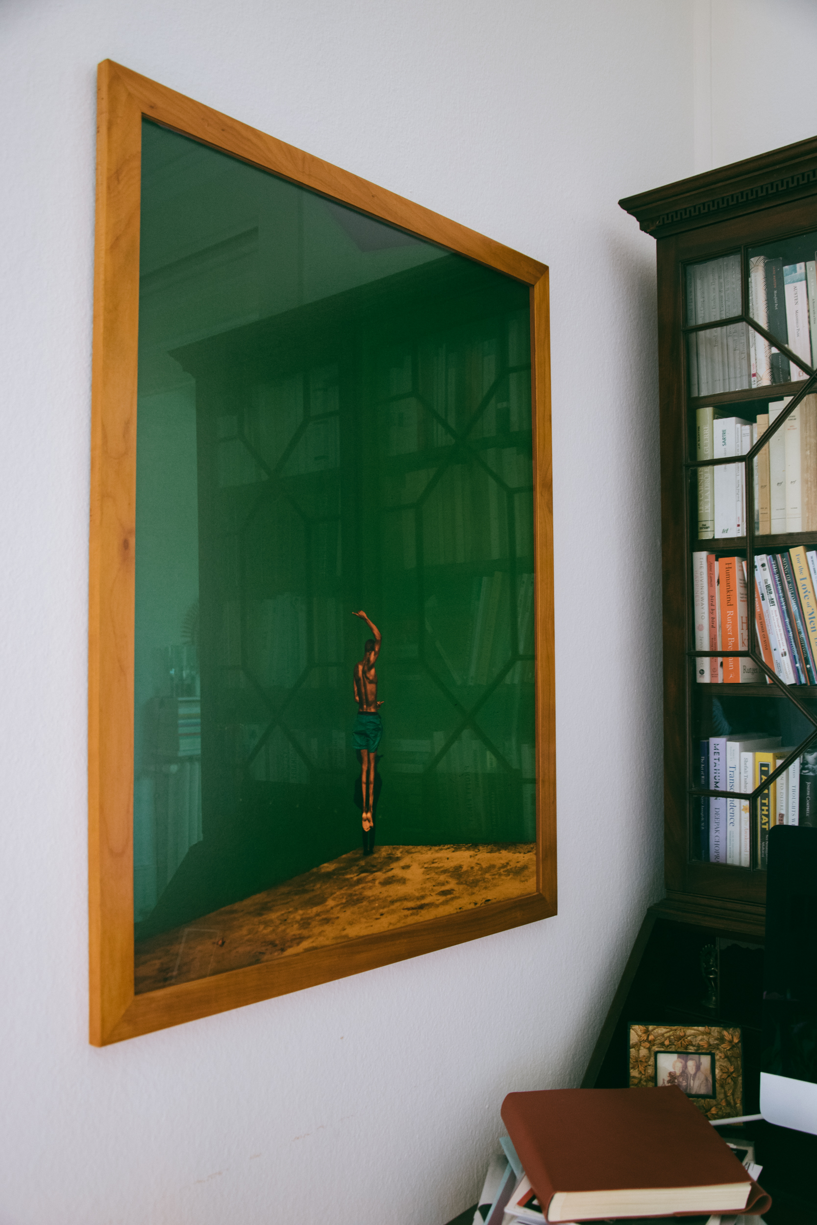 A shot of a photograph by Lougè Delcy next to a vintage desk belonging to Anne's father 