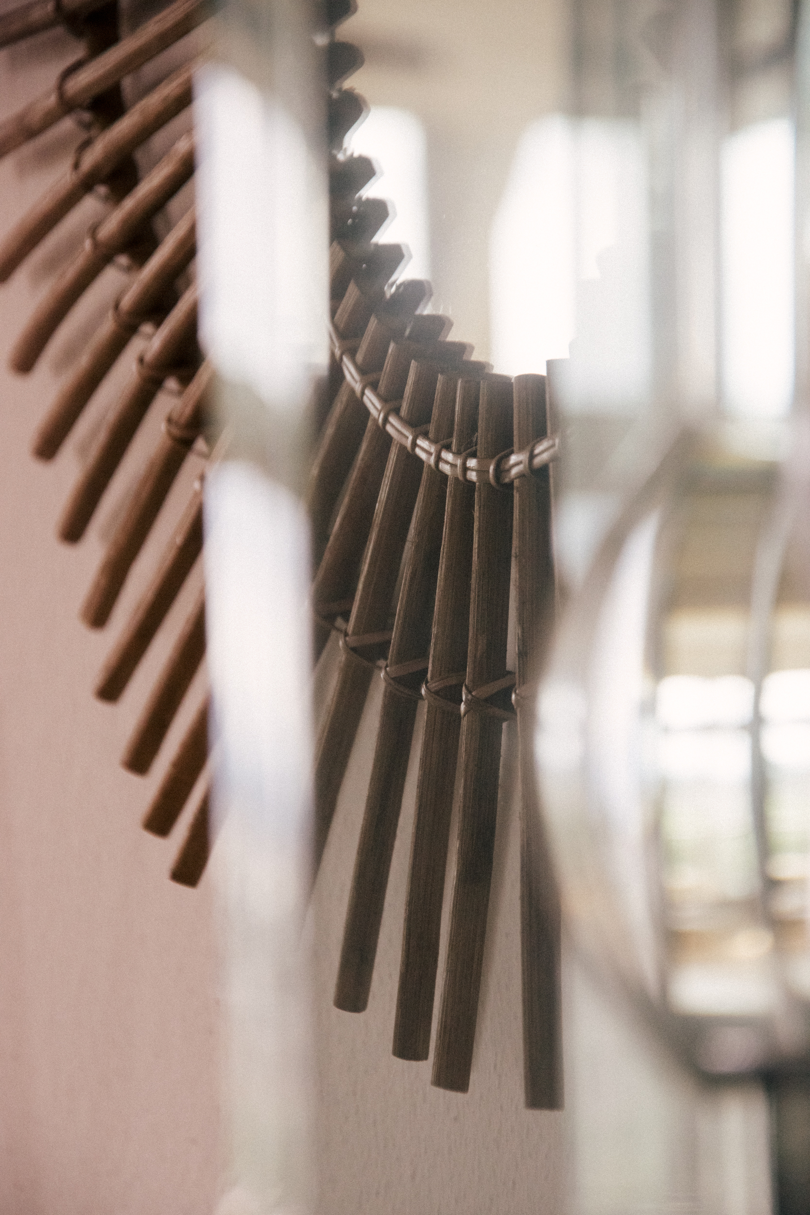 A photograph of a vintage mirror in rattan