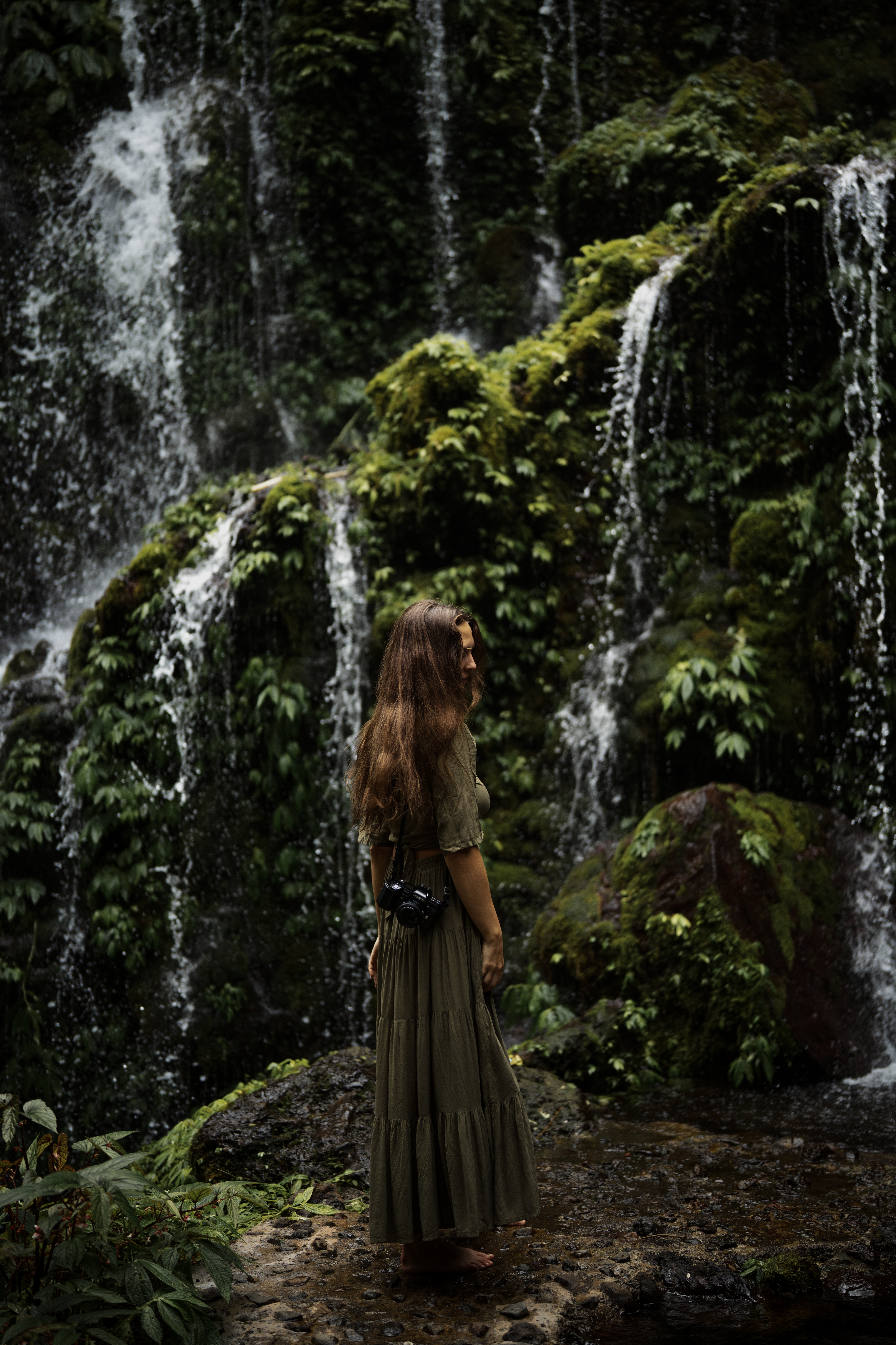 Artist Julia Astok photographed with her camera in the Vietnamese jungle
